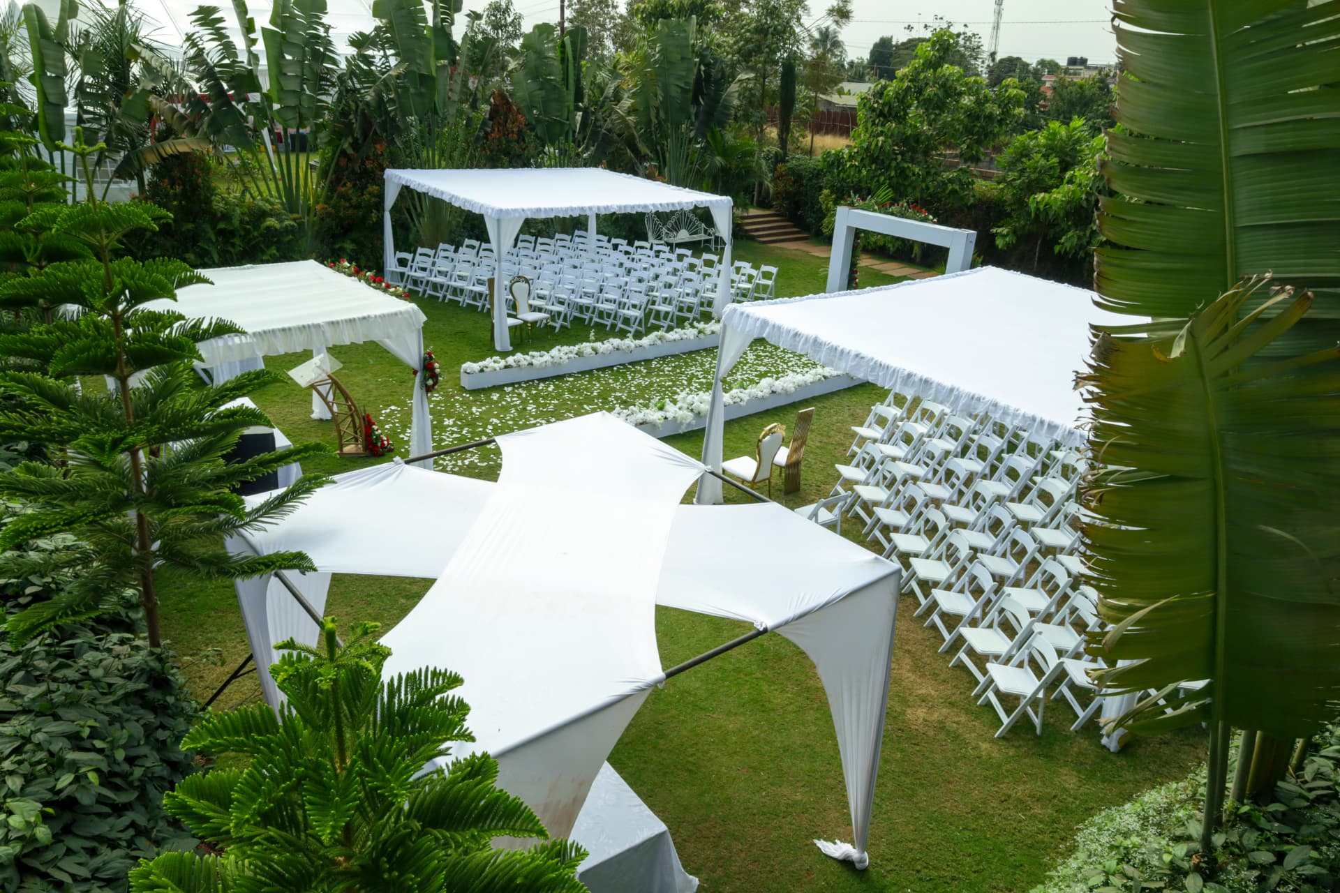 Elevated view of canopies, seating and ceremony spaces across the gardens