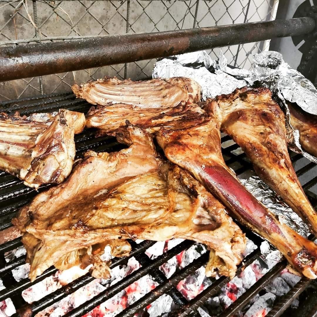 Nyama choma roasting over glowing charcoal on the restaurant grill
