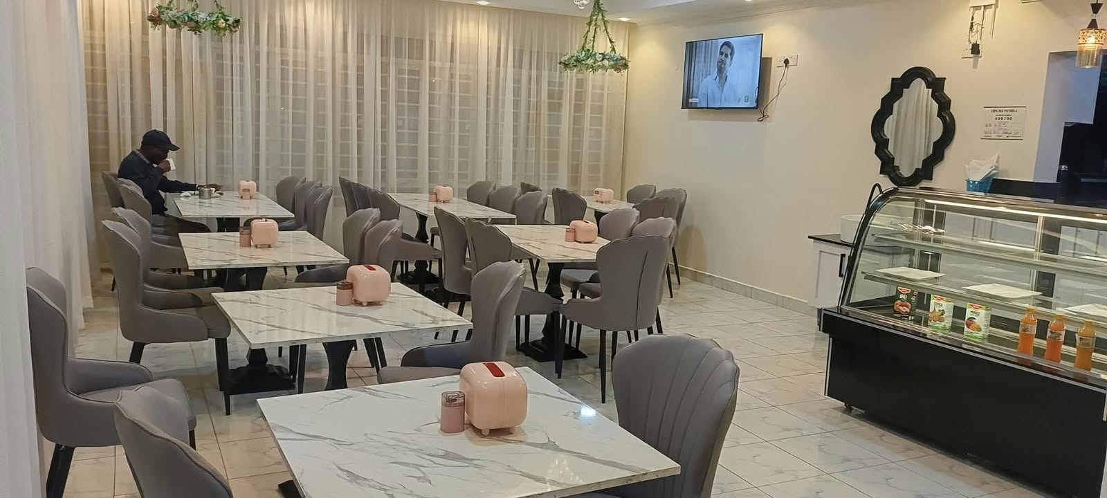 Restaurant interior with neatly arranged tables and upholstered dining chairs