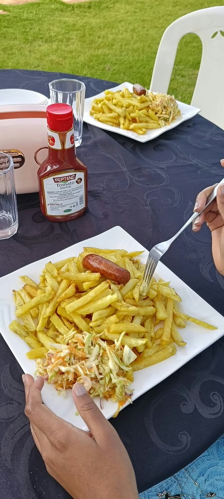 Chips and accompaniments served at an outdoor garden table